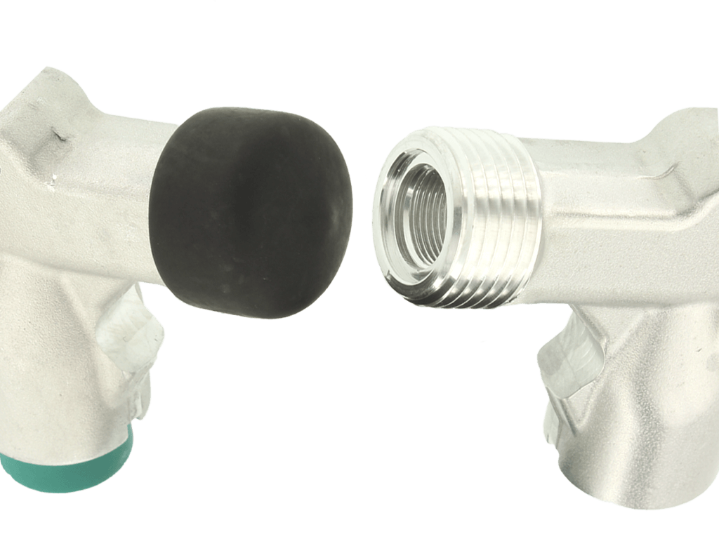 Two metallic L-shaped valve connectors face each other; one with a black rubber cap, the other with exposed threading.