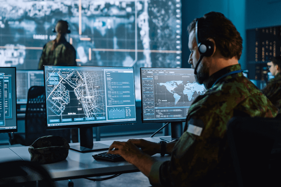 Man with headset in military command center