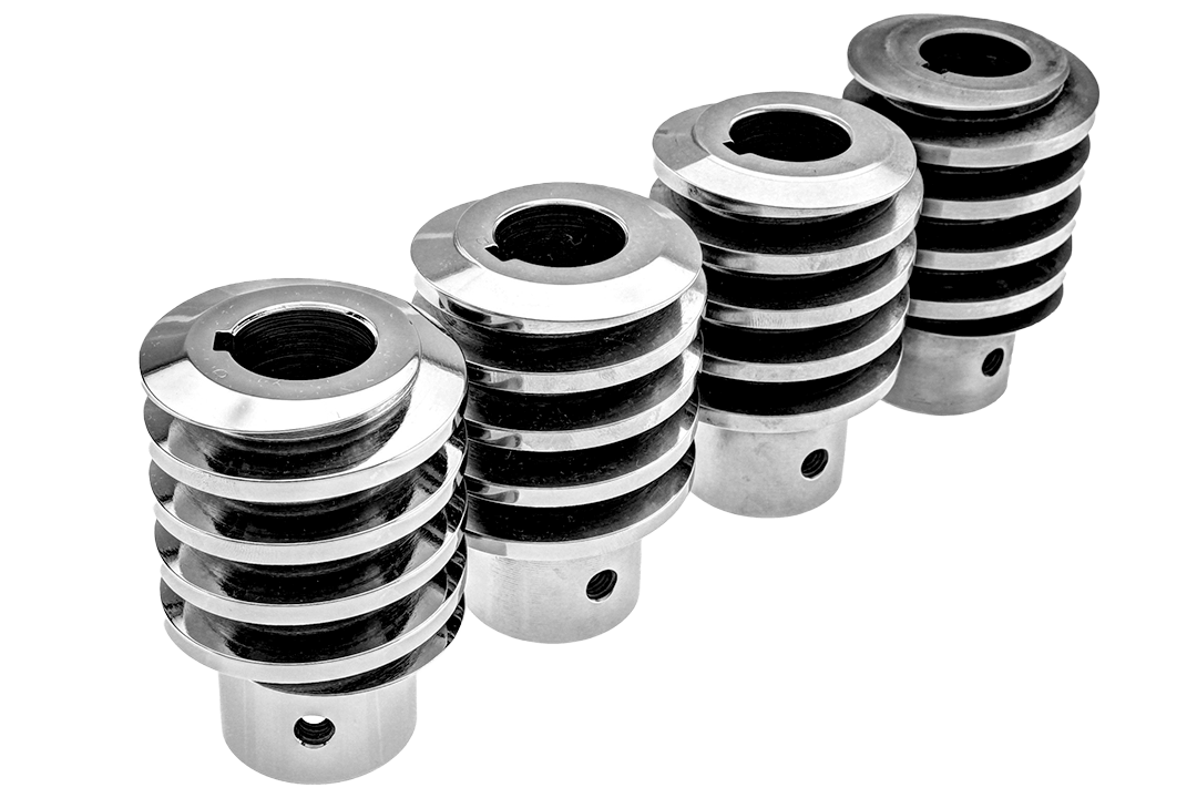 Four polished metal couplings with helical grooves are aligned diagonally. Each coupling has a central hole.