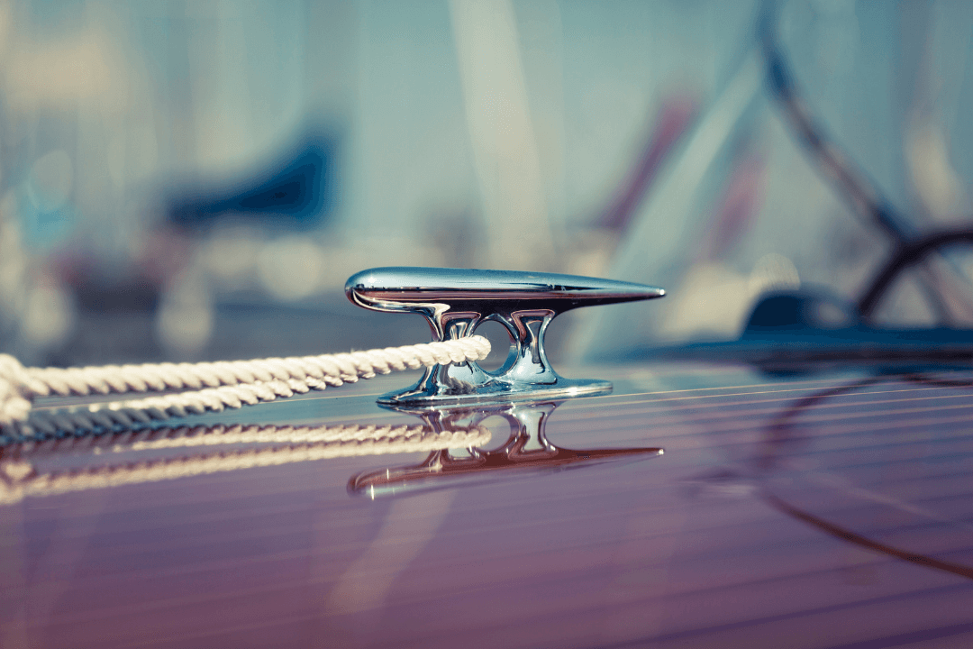 Silver handle on a boat holding a rope