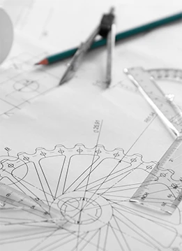 A detailed technical drawing shows geometric designs and measurements, overlaid with a compass, pencil, and ruler, typically used in process engineering.